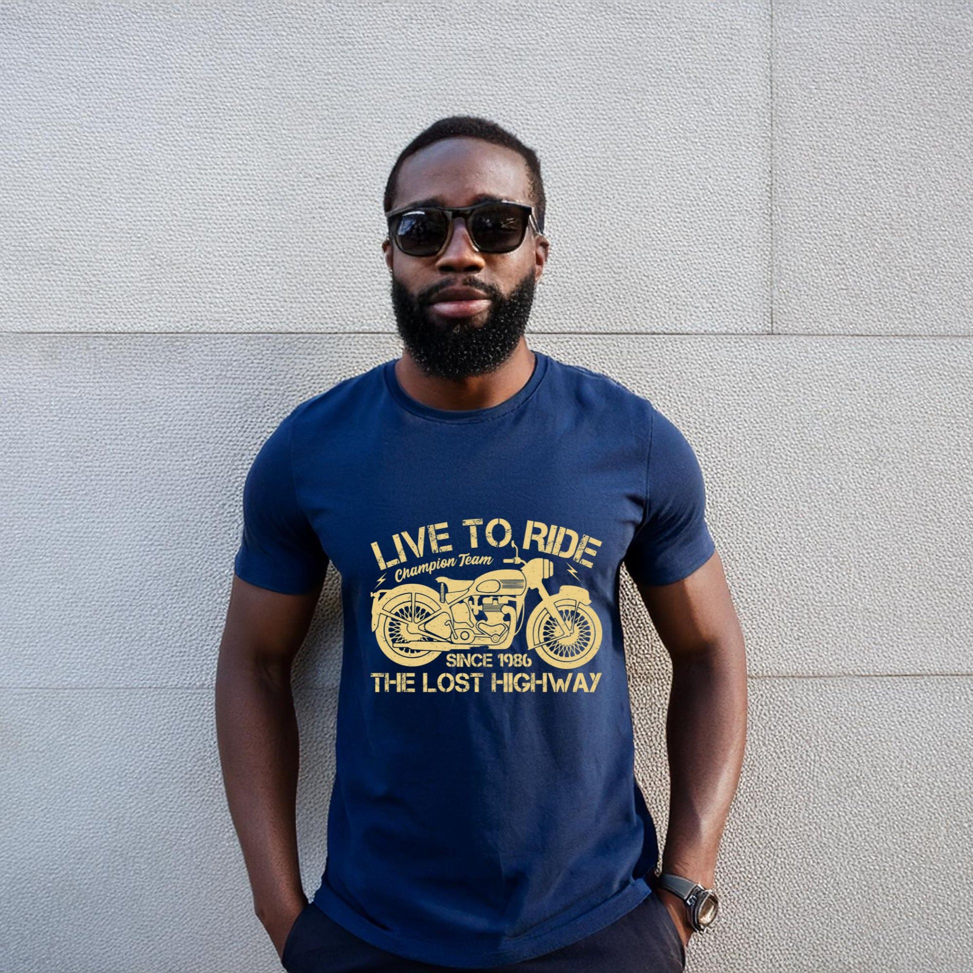 Man wearing a navy blue t-shirt with a vintage motorcycle design and "Live to Ride" text.