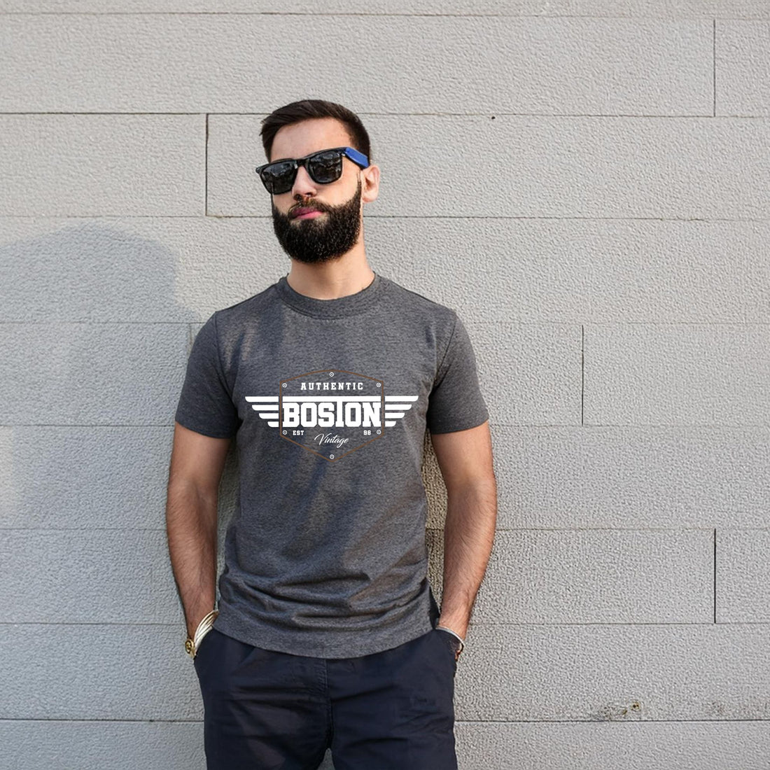 Man wearing a dark gray t-shirt with "Bosion" logo and vintage winged design.