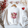 Black sweatshirt with a highland cow graphic wearing a pink bow and blowing bubblegum, surrounded by pink hearts.