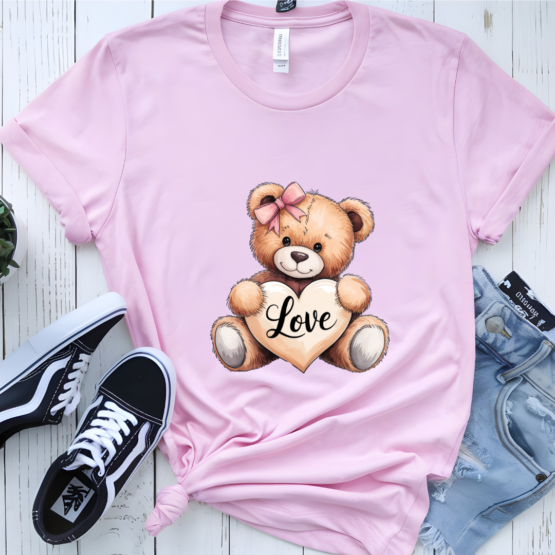 Shop our adorable teddy bear T-shirt featuring a heart that says 'Love.' 