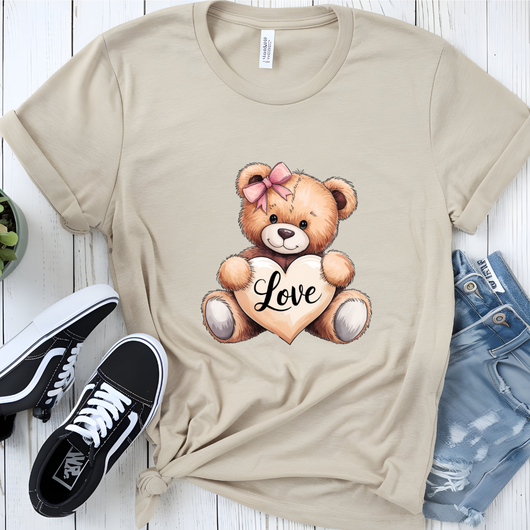 Cute graphic T-shirt with a teddy bear holding a heart that says 'Love,' styled with casual sneakers and distressed jeans