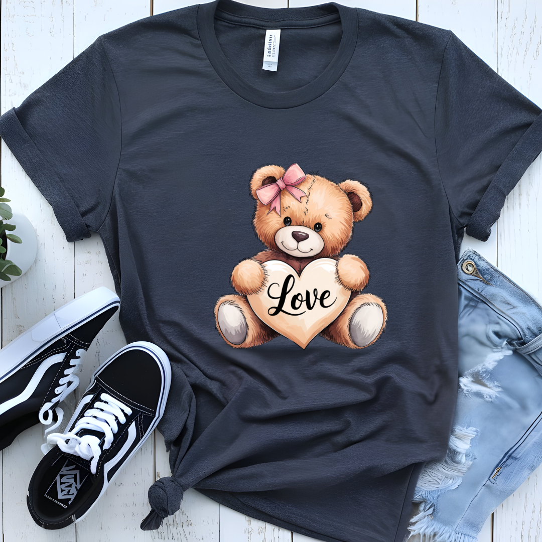 Cute graphic T-shirt with a teddy bear holding a heart that says 'Love,' styled with casual sneakers and distressed jeans
